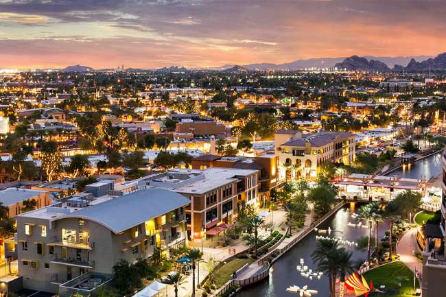 https://assets.experiencescottsdale.com/simpleview/image/upload/c_fill,h_433,q_60,w_650/v1/clients/scottsdale/Waterfront_Canal_overhead_shot_night_79808bfa-f5a8-45af-92f4-e54d150f1c2b.jpg