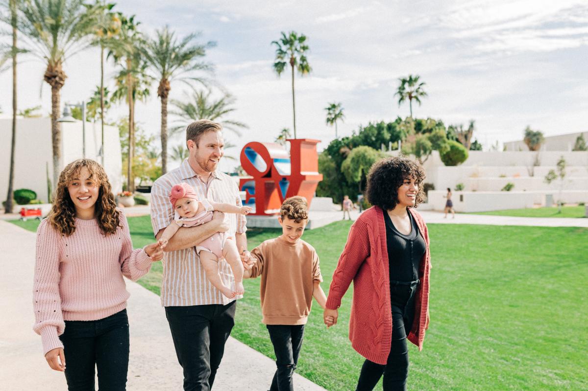 A family enjoying Scottsdale Civic Center Park and Robert Indiana's iconic "LOVE" sculpture in Old Town.