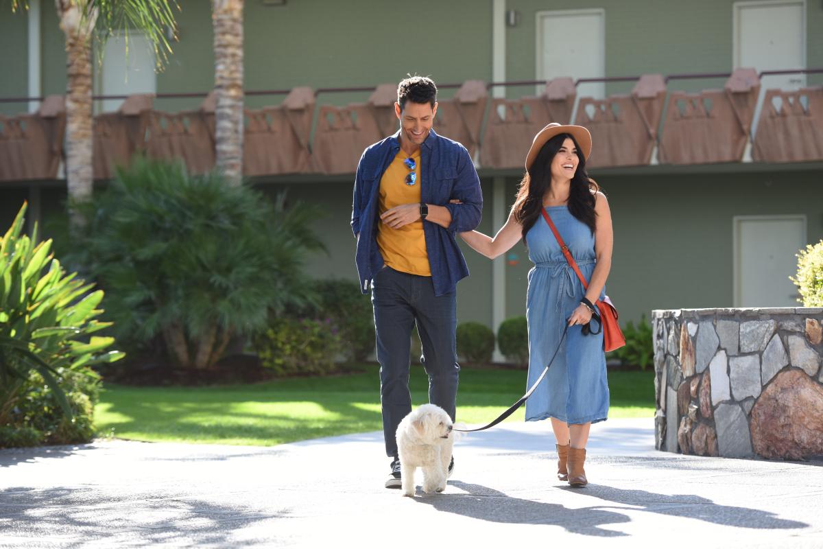 Couple walking pet outside Hotel Valley Ho in Scottsdale