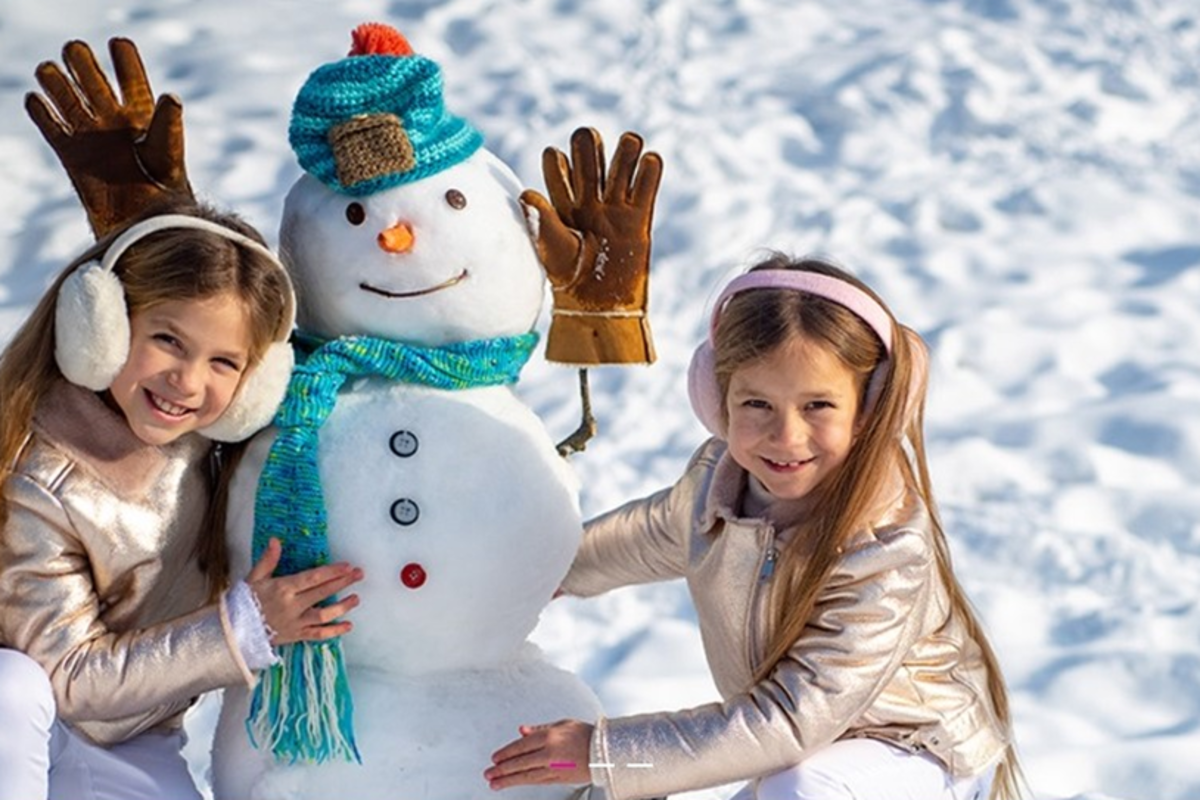 Children building a Snowman at SnowFest in Scottsdale
