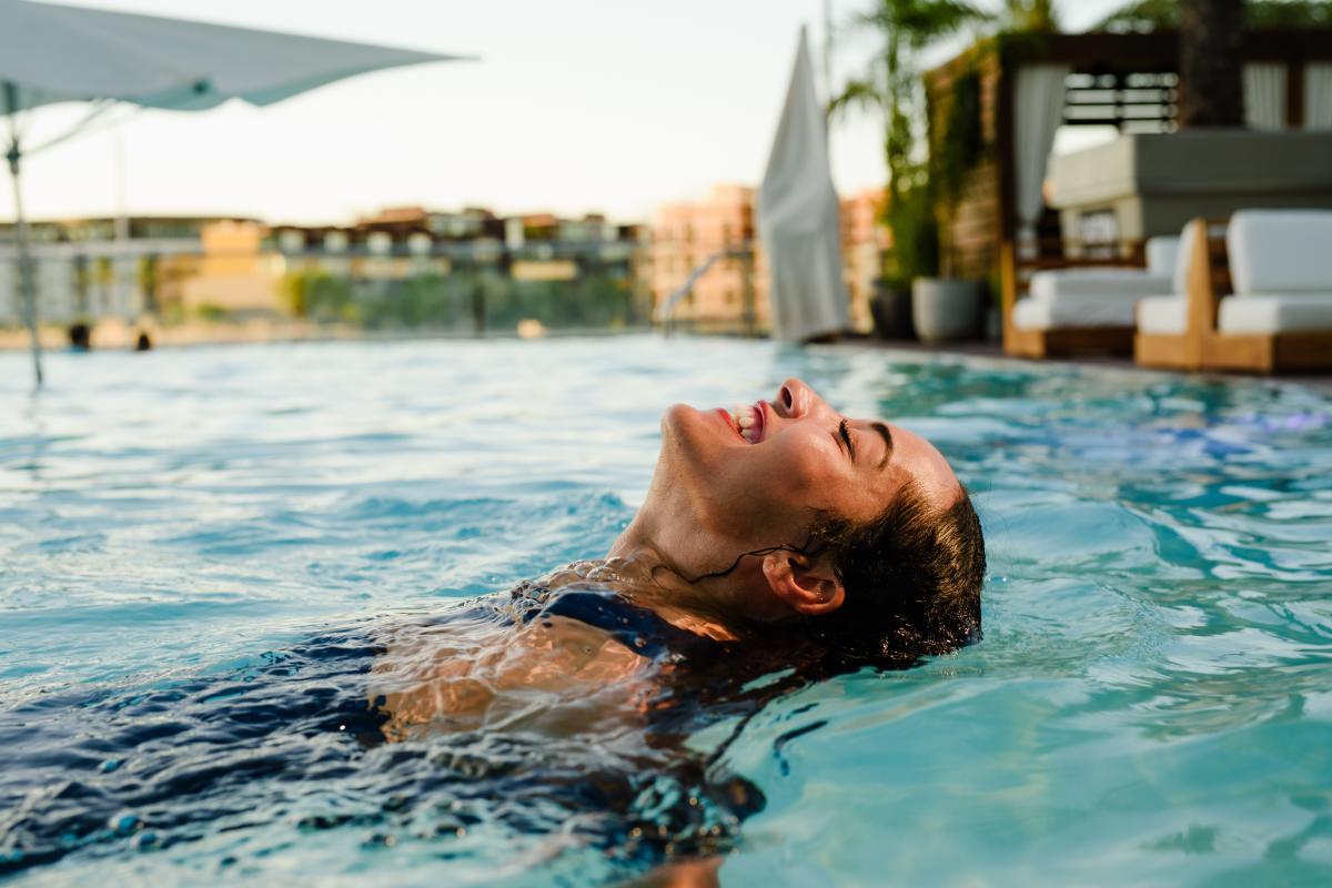 Woman swimming at the wet deck pool at W Scottsdale Hotel in Old Town.